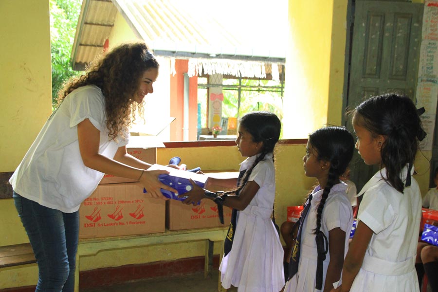 Tourists giving gifts for village children in Sri Lanka 